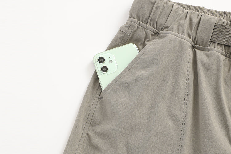 Une paire de shorts d'extérieur CRZ Yoga avec un téléphone portable dans la poche.